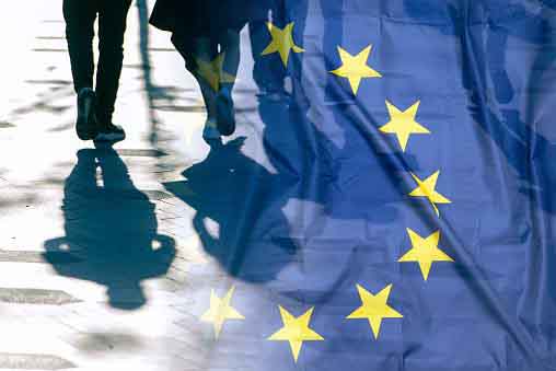 EU or European Union Flag and shadows of people, concept political picture